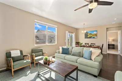 a living room with a couch and chairs and a table at Windshire Retreat with Pool, Garage and Pet-Friendly in Windsor