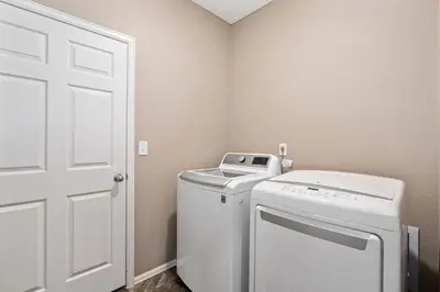 a laundry room with a washer and dryer in it at Windshire Retreat with Pool, Garage and Pet-Friendly in Windsor