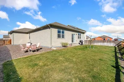 a small house with a yard with a lawn at Windshire Retreat with Pool, Garage and Pet-Friendly in Windsor