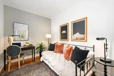 a living room with a couch and a desk at Oak Street Bungalow Walk to Old Town and CSU in Fort Collins