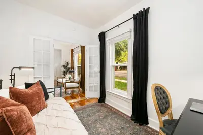 a living room with a couch and a window at Oak Street Bungalow Walk to Old Town and CSU in Fort Collins