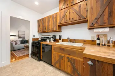 a kitchen with wooden cabinets and a sink at Oak Street Bungalow Walk to Old Town and CSU in Fort Collins