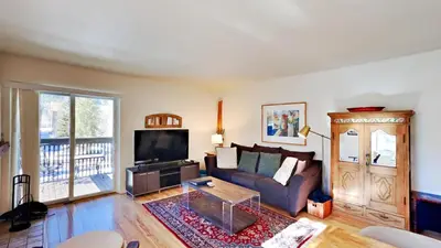 a living room with a couch and a tv at Mountain Side D277 in Frisco
