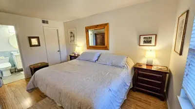 a bedroom with a bed and a bathroom with a mirror at Mountain Side D277 in Frisco