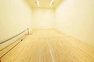 a tennis court with a wooden floor in an empty room at Mountain Side D277 in Frisco