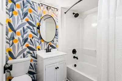 a bathroom with a toilet and a sink and a mirror at Sunset Haven Dog-friendly Home Near Trails and Lake in Fort Collins