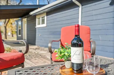a bottle of wine sitting on a table with a glass at Sunset Haven Dog-friendly Home Near Trails and Lake in Fort Collins
