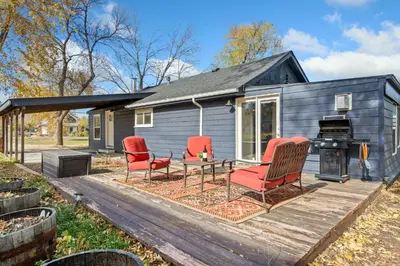 a tiny house with red chairs and a table on a deck at Sunset Haven Dog-friendly Home Near Trails and Lake in Fort Collins