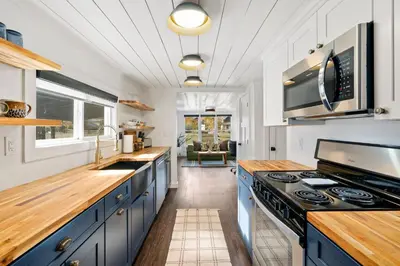 a kitchen with blue cabinets and a stove top oven at Sunset Haven Dog-friendly Home Near Trails and Lake in Fort Collins