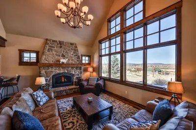 a living room with a couch and a fireplace at Barnwood Beauty at Grand Elk- Pet Friendly- Hot Tub Private Golf Ski Games in Granby