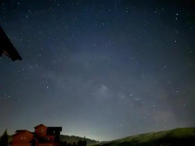 a starry night with a house on a hill at Barnwood Beauty at Grand Elk- Pet Friendly- Hot Tub Private Golf Ski Games in Granby