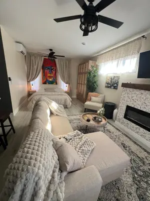 a large living room with a couch and a ceiling fan at Su Casa Studio in Denver