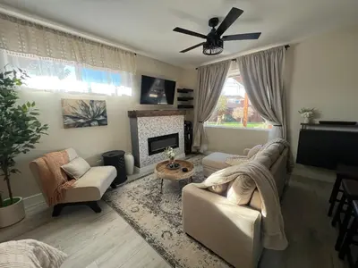 a living room with a couch and a fireplace at Su Casa Studio in Denver