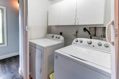 a white laundry room with a washer and dryer at 10-Person HotTub, ViewHouse, Steps to Trail, Close to Ski Resorts, FirePit in Silverthorne