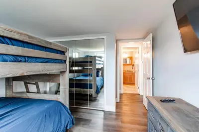 a bedroom with a bunk bed and a mirror at 10-Person HotTub, ViewHouse, Steps to Trail, Close to Ski Resorts, FirePit in Silverthorne