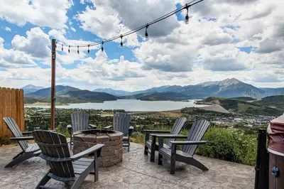 a patio with chairs and a fire pit and mountains at 10-Person HotTub, ViewHouse, Steps to Trail, Close to Ski Resorts, FirePit in Silverthorne