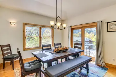a dining room with a wooden table and chairs at Mtn-View Cabin with Private Hot Tub in Georgetown! in Georgetown