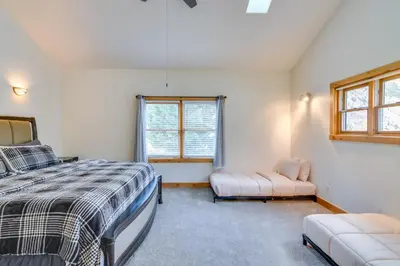 a bedroom with a bed and a window at Mtn-View Cabin with Private Hot Tub in Georgetown! in Georgetown