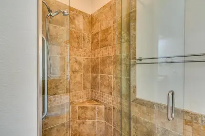 a bathroom with a shower with a glass door at Mtn-View Cabin with Private Hot Tub in Georgetown! in Georgetown