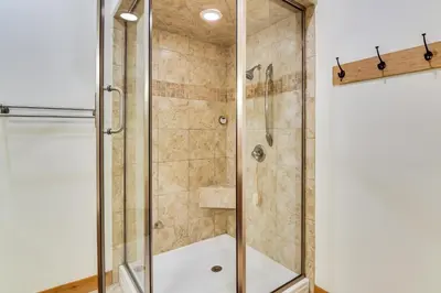 a bathroom with a shower with a glass door at Mtn-View Cabin with Private Hot Tub in Georgetown! in Georgetown