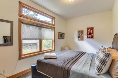 a bedroom with a bed and a window at Mtn-View Cabin with Private Hot Tub in Georgetown! in Georgetown