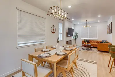 a dining room and living room with a table and chairs at Great for Families! Newly Built Home in Aurora in Aurora