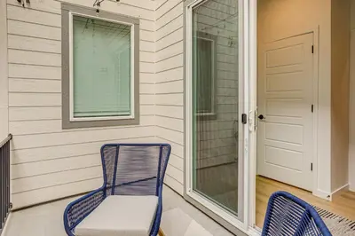 a porch with a blue chair and a window at Great for Families! Newly Built Home in Aurora in Aurora