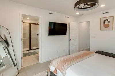 a bedroom with a bed and a tv on a wall at Great for Families! Newly Built Home in Aurora in Aurora
