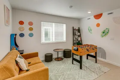 a living room with a couch and a table at Great for Families! Newly Built Home in Aurora in Aurora