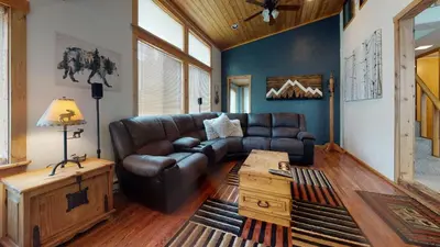a living room with a leather couch and a table at #160 Tiger Run in Breckenridge