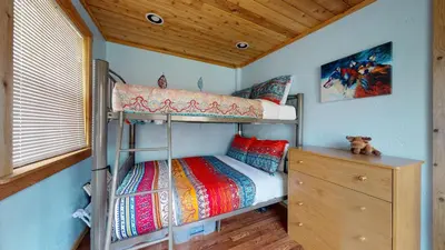 a bedroom with two bunk beds and a wooden ceiling at #160 Tiger Run in Breckenridge
