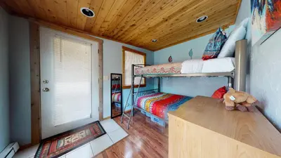 a bedroom with two bunk beds and a wooden ceiling at #160 Tiger Run in Breckenridge