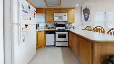 a kitchen with white appliances and wooden cabinets at #160 Tiger Run in Breckenridge