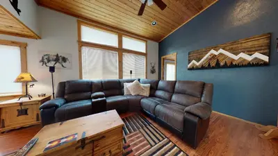 a living room with a leather couch and a table at #160 Tiger Run in Breckenridge