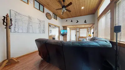 a leather couch in a living room with a ceiling at #160 Tiger Run in Breckenridge