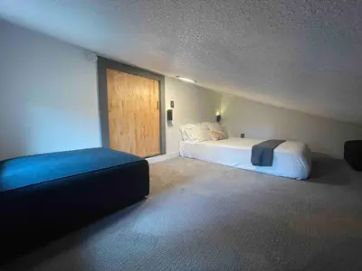 a bedroom with a bed and a sliding glass door at Blue Owl - Tree House Views! Couples Getaway! in Idaho Springs