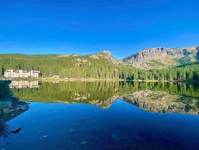 a view of a lake with mountains in the background at Blue Owl - Tree House Views! Couples Getaway! in Idaho Springs