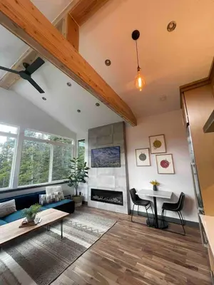 a living room with a couch and a table at Blue Owl - Tree House Views! Couples Getaway! in Idaho Springs