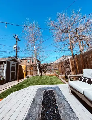 a backyard with a wooden deck with a couch at Blue Ox Charming 2 Bedroom Triplex - S Broadway in Denver