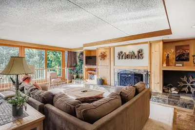 a living room with a couch and a fireplace at 1806 Decatur condo in Keystone