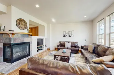 a living room with a couch and a fireplace at Red Quill Basecamp in Winter Park