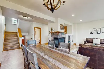 a living room with a wooden table and a couch at Red Quill Basecamp in Winter Park