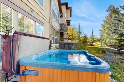a hot tub sitting outside of a house at Red Quill Basecamp in Winter Park