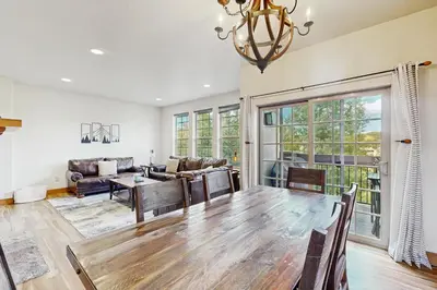 a living room with a table and a couch at Red Quill Basecamp in Winter Park