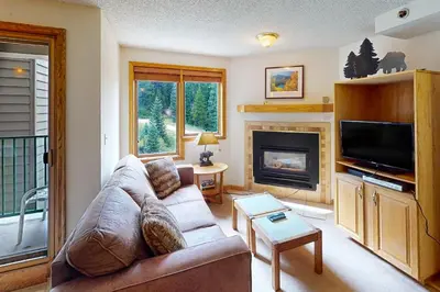 a living room with a couch and a fireplace at Iron Horse Resort 5064 in Winter Park