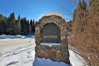 a sign for ahow house in the snow at Iron Horse Resort 5064 in Winter Park