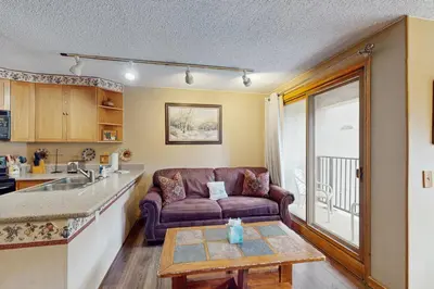 a living room with a couch and a table at Iron Horse Resort 3063 in Winter Park