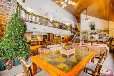 a christmas tree in a living room with a table at Iron Horse Resort 3063 in Winter Park