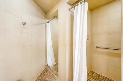 a shower with a white shower curtain in a bathroom at Iron Horse Resort 3063 in Winter Park