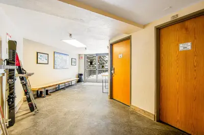 a hallway with a room with a door and skis at Iron Horse Resort 3063 in Winter Park